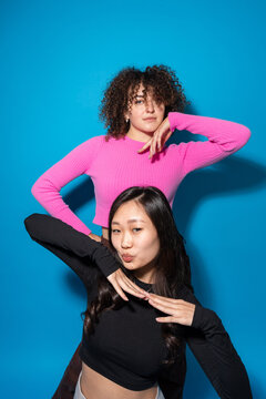 Positive multiracial women against blue background