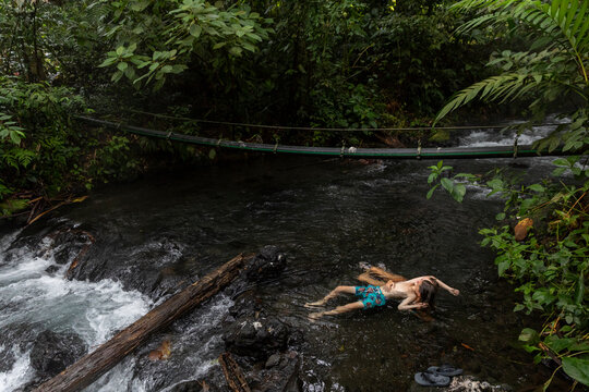 Family together travel in Costa Rica mother  son swimm in hot spring
