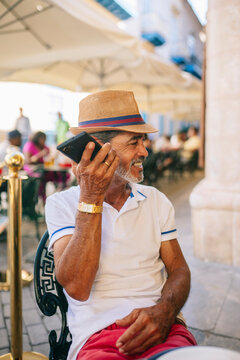 Cuban man listening to voice message