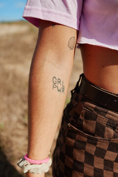 Crop woman with feminist tattoo