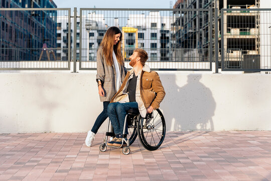 Portrait of Handsome Man in Wheelchair and Girlfriend