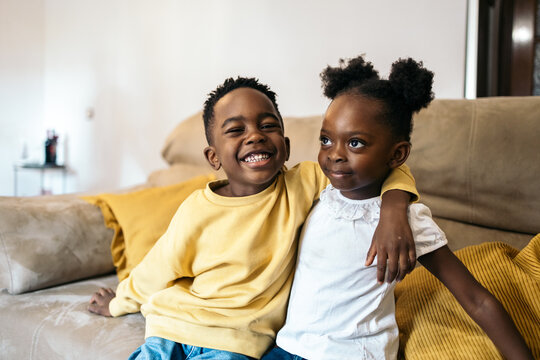 Portrait of smiling little black siblings at home