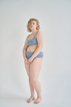 Young curvy woman in gray underwear