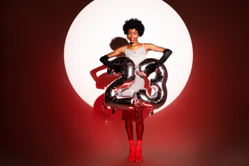 Happy woman holding numbers 2023