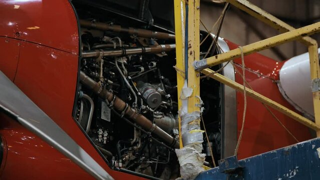 Mechanics Working On An Airplane Engine