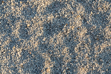 Close-up of white stones on the seashore, background of small stones