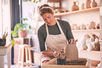 Pottery wheel, mold and woman design sculpture, clay manufacturing process or art product. Creative retail store, craft process and startup small business owner, employee or artist in studio workshop