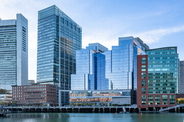 Boston waterfront with old brick houses and new glass skyscrapers in New England