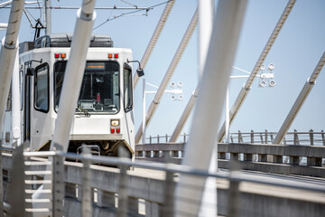 Modern urban passenger tram moves on the rails on the Tilikum Crossing Bridge over the Willamette River in Portland