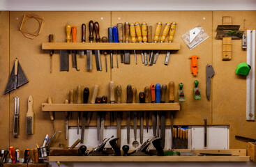 Luthier tools hanging on wall