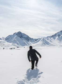 Man wandering  in the deep snow-covered plateau
