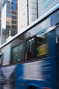 Blue bus passing on the road