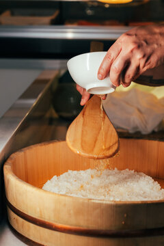 Chef preparing special japanese rice for making makis