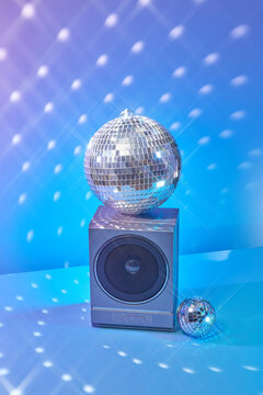 Vintage loudspeaker decorated with disco sphere.