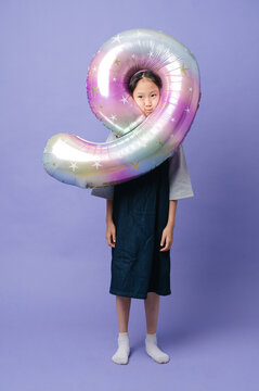 Cute girl with big ballon of number 9