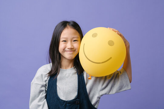 Cute little girl with a yellow balloon