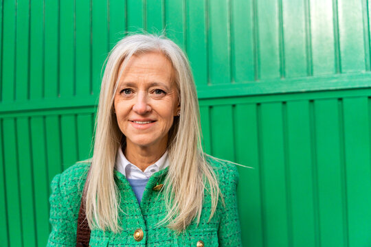 Green Portrait Of A Fashionable Businesswoman Looking At Camera.