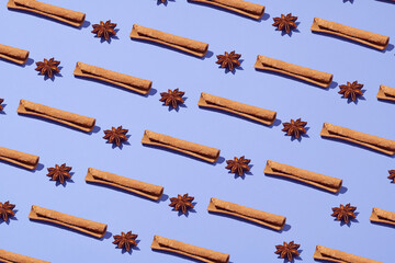 Composition made of star anise and cinnamon sticks isolated on purple.