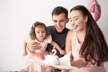 Happy multinational family, asian mother coucasian father and daughter celebrate the birthday of...