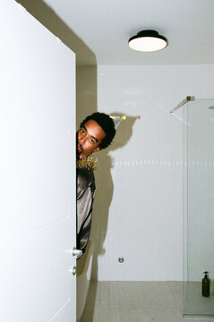 Man Peeking Behind Door
