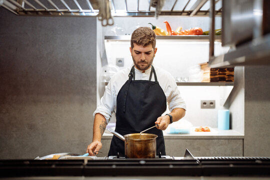 Concentrated chef cooking in kitchen