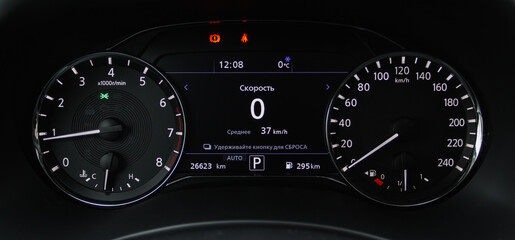 Modern car dashboard with speedometer, tachometer. Car dashboard. Car dashboard details. Modern car interior. The speedometer of a modern. Translation "Speed. Average. Hold button to reset."
