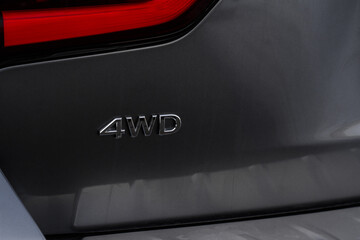 4WD emblem on modern SUV car detail close up view. Four Wheel Drive chrome badge.