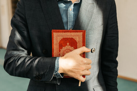 man holding Quran