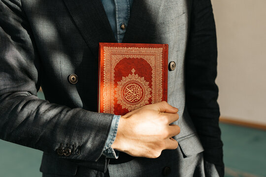 man holding Quran