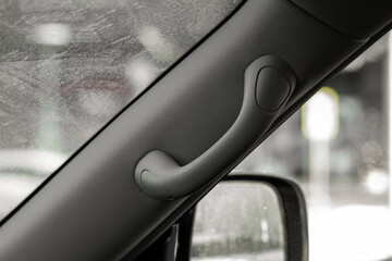 Modern car grab handle, car interior details. Car grab handler for the passenger. Car ceiling...