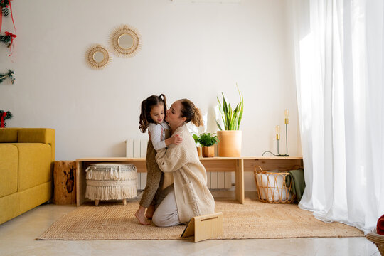 Woman Enjoying With Her Daughters At Living Room 