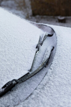 Fototapeta Car Covered in Light snow frost with wiper blades frozen on windscreen