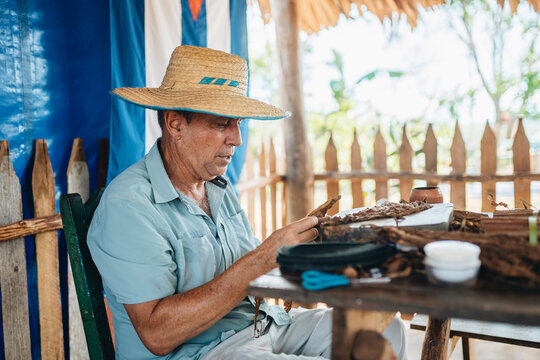 Man in hat making Cuban cigars