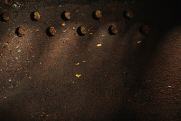 Rusty metal plate- corrosion on a dark red background. Abstract rust texture