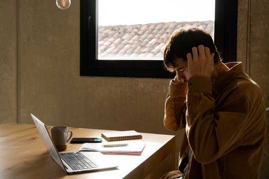 Man paying utility bills  from home 