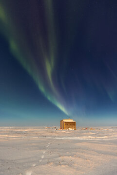 Northern lights on the house in the tundra