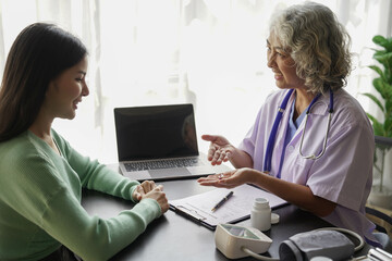  consulting female patient about pills and discussing health treatment sitting in the office at the desk. Medicine and health care concept. Doctor prescribing medicine to patient in the office.
