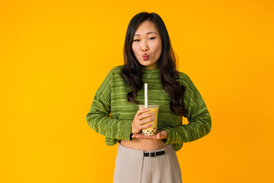 Asian woman holding fresh bubble tea