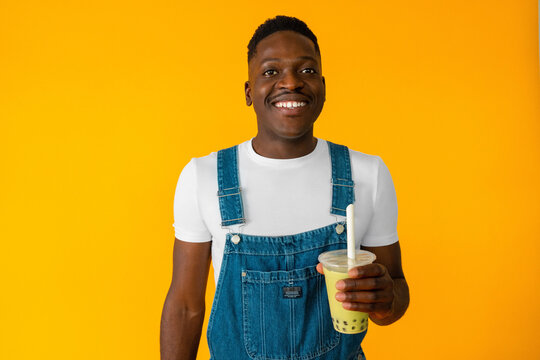 Black man smiling while drinking bubble tea