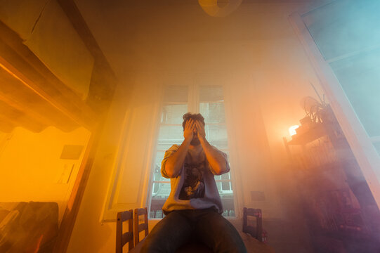 Man suffering from depression in surreal indoor scenery