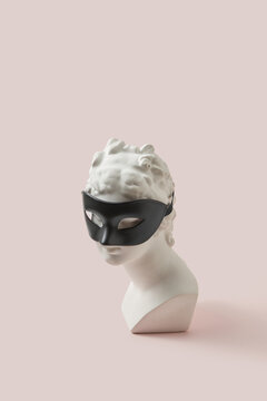 Gypsum goddess bust wearing black fetish mask.