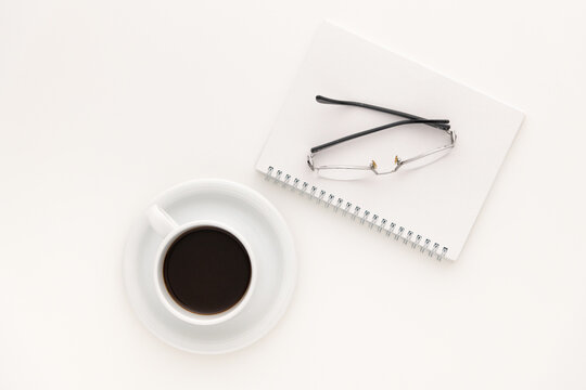 Coffee, notebook and glasses. Still life image.
