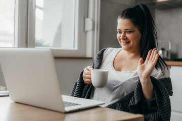 Overweight caucasian woman has a video call