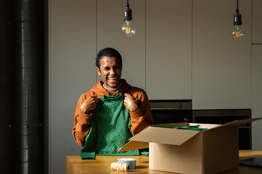 Man Opening Delivery Box From Second Hand Shop