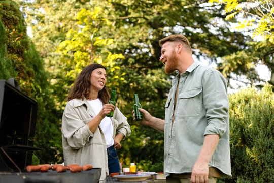 Man and Woman Toasting at Barbecue Party 
