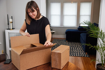 Woman opening a shipment received by mail