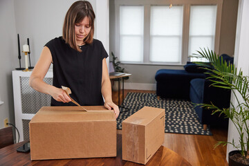Woman opening a shipment received by mail