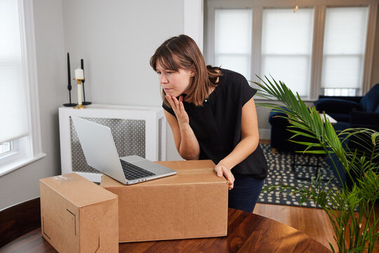 Woman prepares packages for shipment