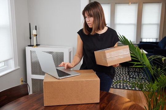 Woman prepares packages for shipment