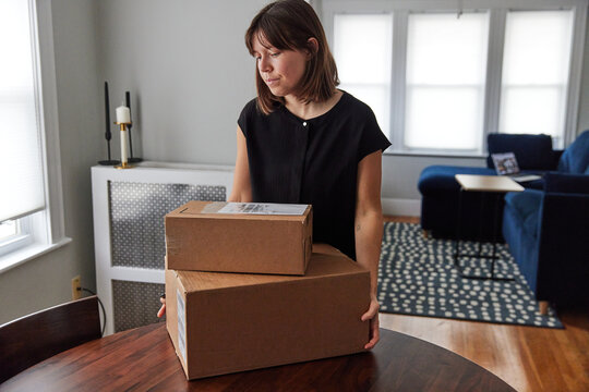 Woman prepares packages for shipment